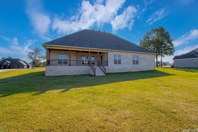 rear view of property with a yard