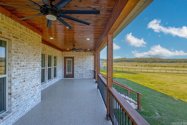 view of patio / terrace with ceiling fan and a rural view