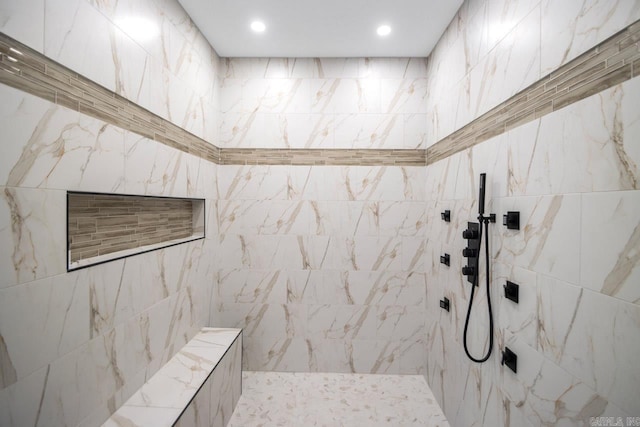 bathroom featuring a tile shower