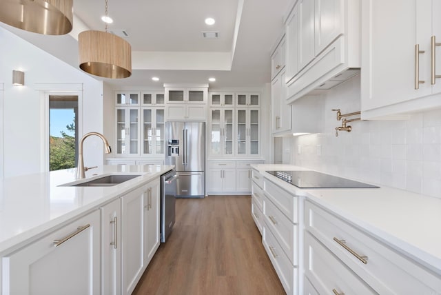 kitchen with stainless steel appliances, white cabinets, sink, and dark wood-type flooring