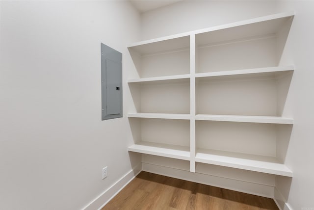 room details with electric panel and hardwood / wood-style flooring