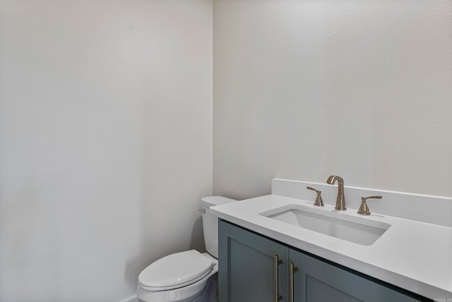 bathroom featuring toilet and vanity