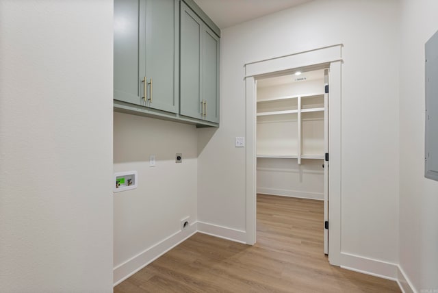 washroom featuring hookup for a washing machine, cabinets, light hardwood / wood-style flooring, and hookup for an electric dryer