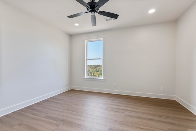 empty room with light hardwood / wood-style flooring and ceiling fan