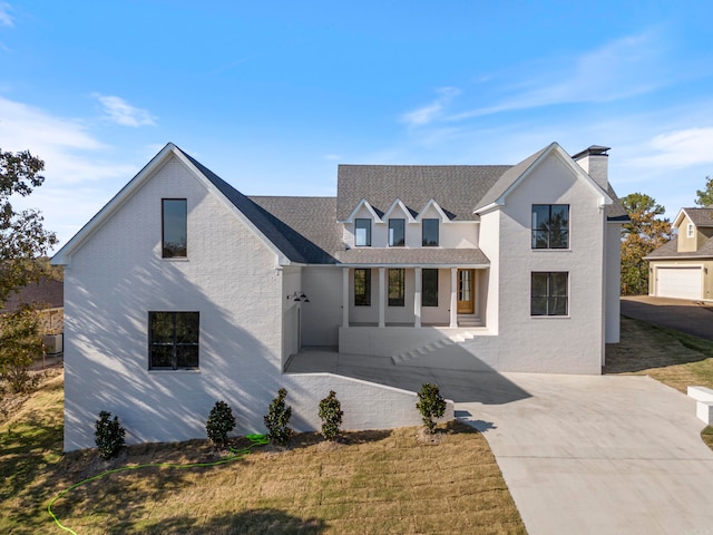 view of front of home with a front yard and a garage