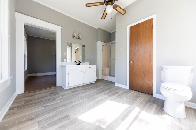 bathroom with walk in shower, wood-type flooring, vanity, and toilet