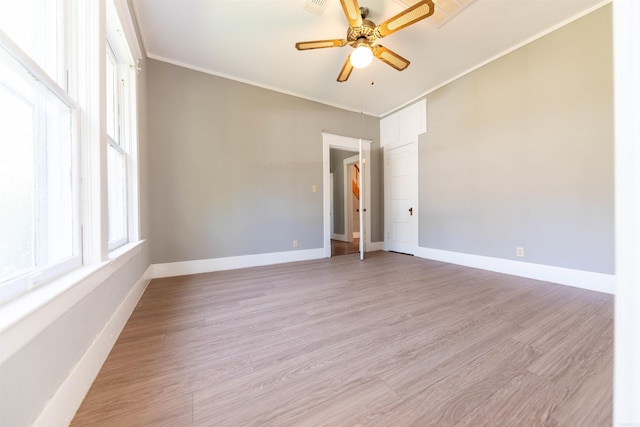 spare room featuring light hardwood / wood-style floors, ornamental molding, and ceiling fan