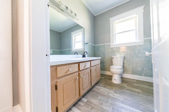 bathroom with toilet, crown molding, tile walls, hardwood / wood-style flooring, and vanity