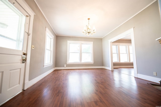 interior space with crown molding, a chandelier, and dark hardwood / wood-style flooring