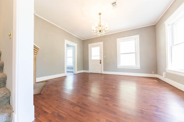 entrance foyer featuring ornamental molding, plenty of natural light, and dark wood-type flooring