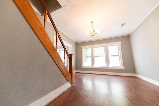 interior space featuring an inviting chandelier, crown molding, and dark hardwood / wood-style flooring