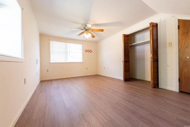 unfurnished bedroom featuring crown molding, ceiling fan, and wood-type flooring