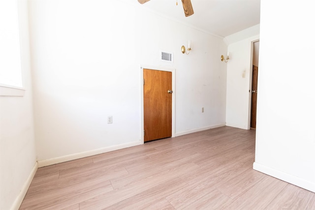 unfurnished room with ceiling fan and light wood-type flooring