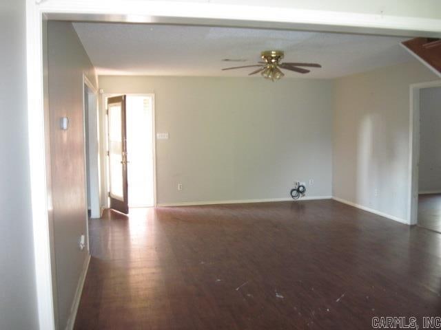 unfurnished room featuring ceiling fan and dark hardwood / wood-style flooring