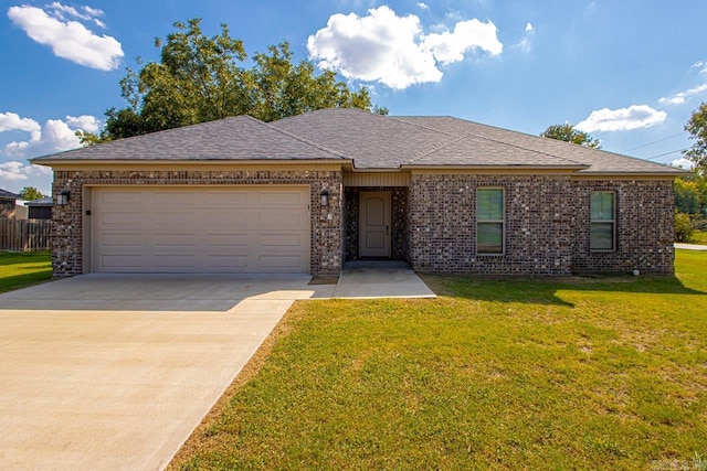 view of front of property featuring a front lawn and a garage