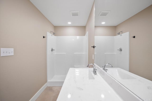 bathroom with a shower and vanity