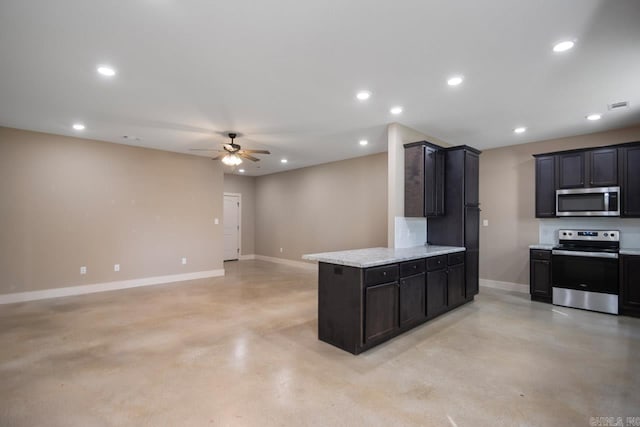 kitchen with light stone counters, ceiling fan, and stainless steel appliances