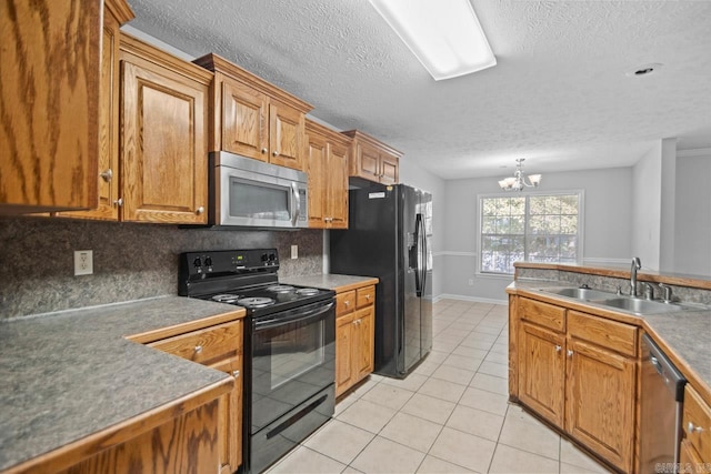 kitchen featuring backsplash, a chandelier, sink, and black appliances