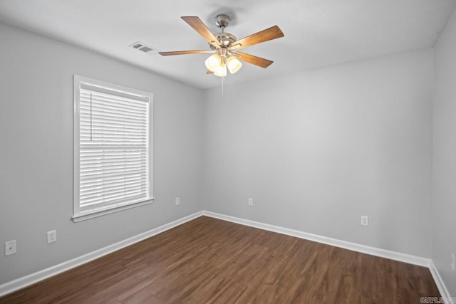 empty room featuring ceiling fan and dark hardwood / wood-style flooring