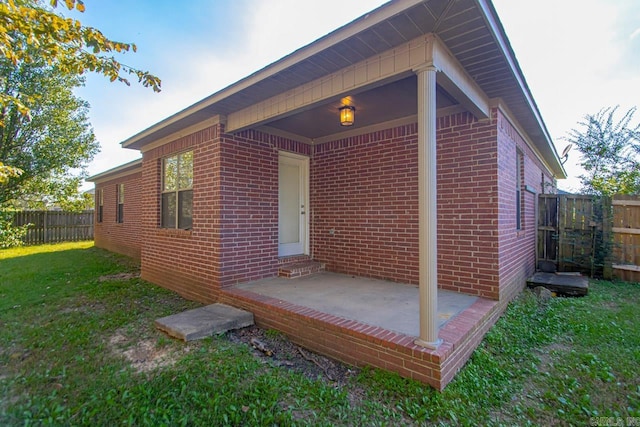 exterior space with a front yard and a patio area