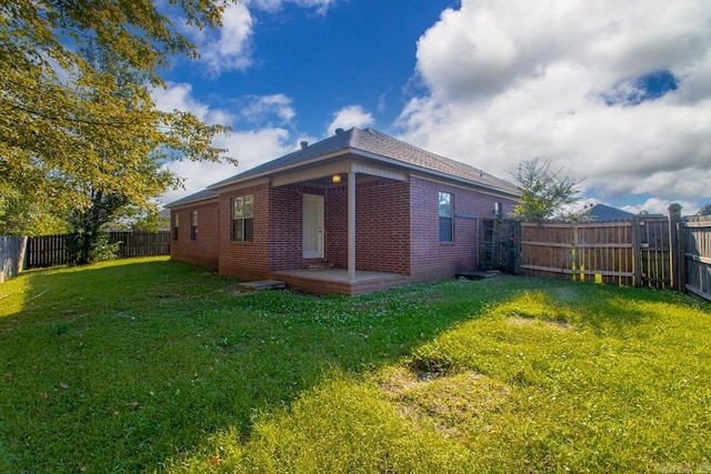 rear view of property with a yard