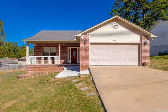 ranch-style house featuring a garage, a front yard, and covered porch