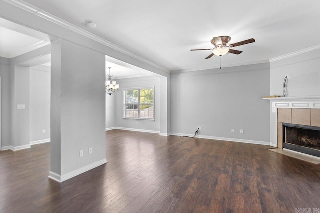 unfurnished living room with ceiling fan with notable chandelier, ornamental molding, dark hardwood / wood-style flooring, and a tile fireplace