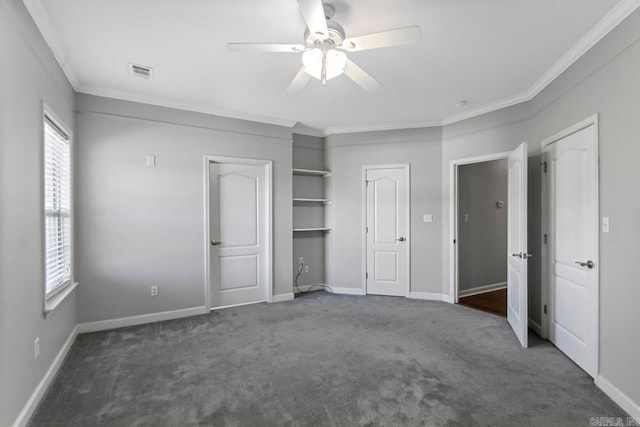 unfurnished bedroom with ornamental molding, dark colored carpet, and ceiling fan