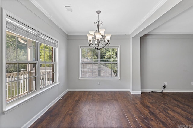 unfurnished dining area with dark hardwood / wood-style floors, a chandelier, and ornamental molding