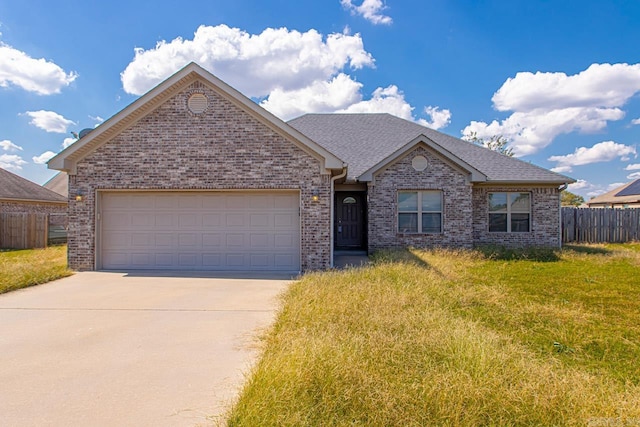 view of front of property featuring a garage and a front lawn