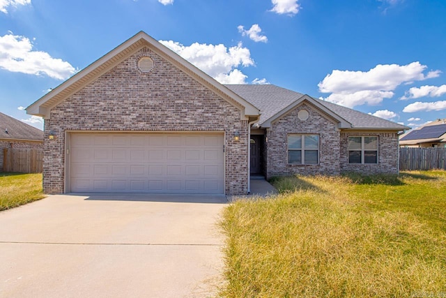 view of front of property with a front yard and a garage