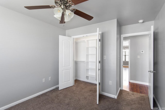 unfurnished bedroom featuring ceiling fan, a closet, and dark carpet