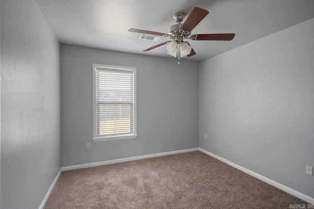 carpeted empty room featuring ceiling fan