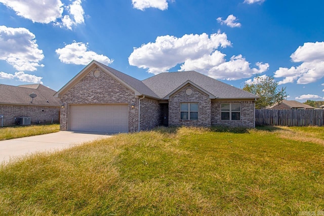 view of front of property with central air condition unit, a garage, and a front lawn