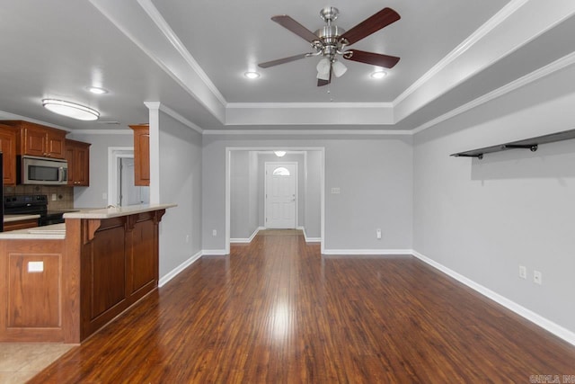 kitchen featuring black range with electric stovetop, crown molding, dark hardwood / wood-style flooring, and a breakfast bar