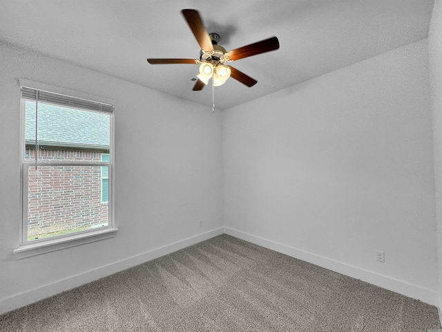 empty room featuring ceiling fan and carpet flooring