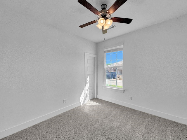 carpeted empty room featuring ceiling fan