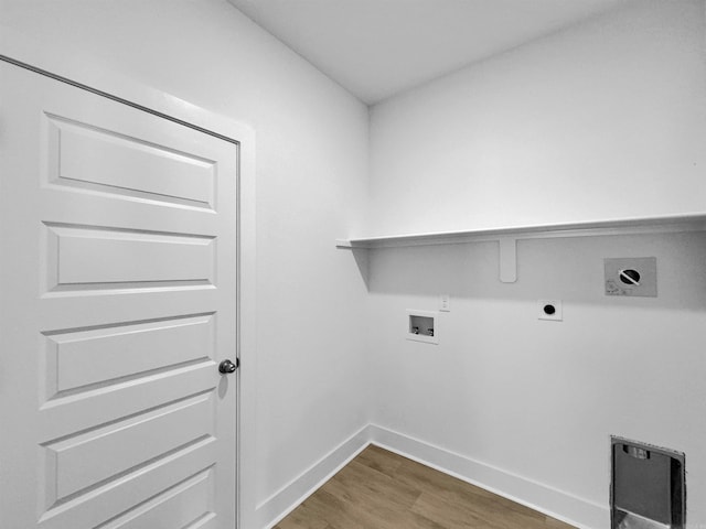 washroom featuring gas dryer hookup, hookup for a washing machine, dark wood-type flooring, and hookup for an electric dryer