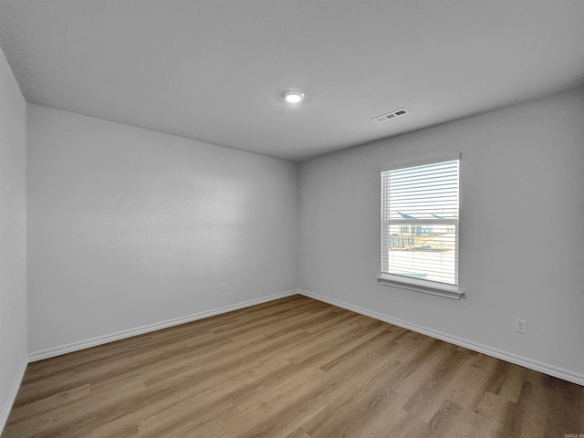 spare room with light hardwood / wood-style flooring