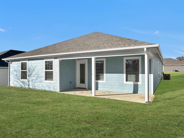 back of property with a yard, a patio area, and central air condition unit