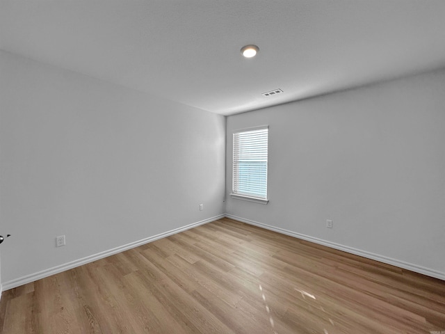 spare room with light hardwood / wood-style flooring