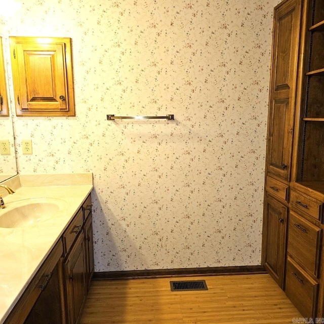 bathroom featuring vanity and hardwood / wood-style floors