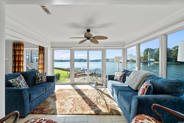 sunroom with ceiling fan, a water view, and a healthy amount of sunlight