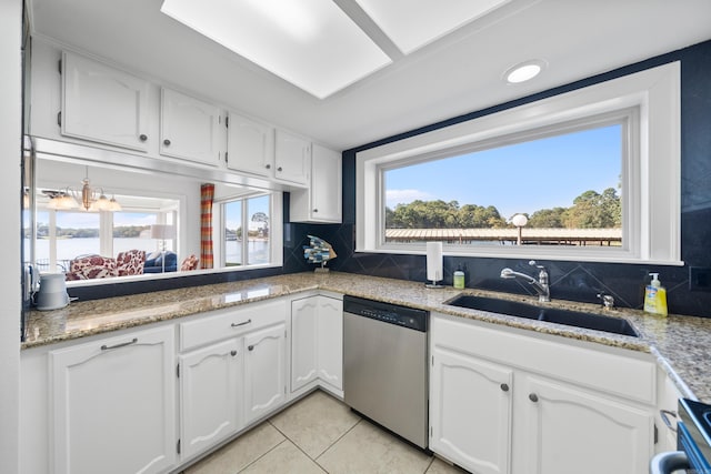 kitchen featuring stainless steel appliances, white cabinets, decorative backsplash, and a healthy amount of sunlight