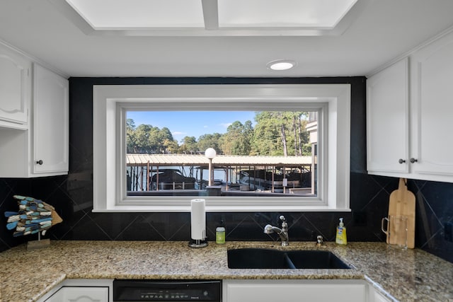 kitchen featuring dishwasher, sink, decorative backsplash, and white cabinetry