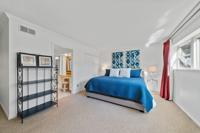 bedroom with crown molding, a closet, and carpet flooring