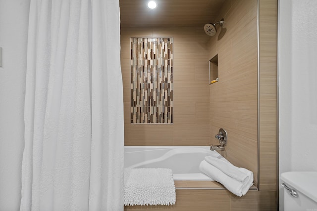 bathroom with shower / bath combo with shower curtain and toilet