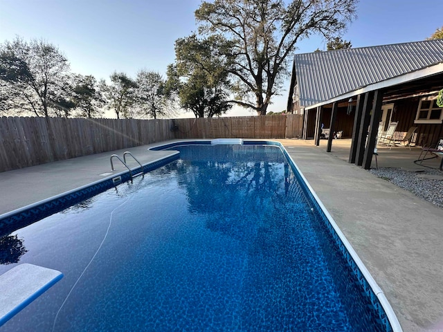 pool at dusk with a patio