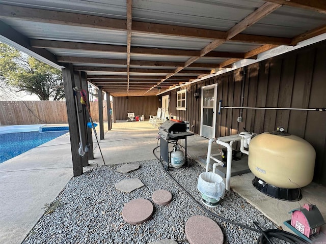 view of patio featuring a fenced in pool and a grill