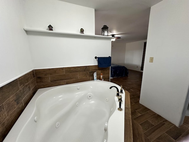 bathroom featuring a tub and ceiling fan